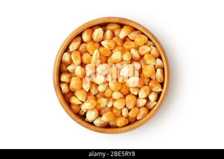 Dried corn kernels in wooden bowl on white background Stock Photo