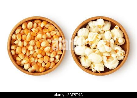 Dried corn kernels and popped popcorn in wooden bowls on white background Stock Photo