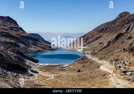 Beautiful view of the Tsomgo Lake and the surrounding dry barren mountainous landscape during December at Sikkim, India Stock Photo