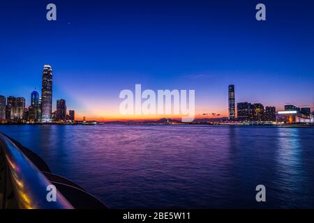 City view of Victoria Harbour of Hong Kong at Magic Hour Stock Photo