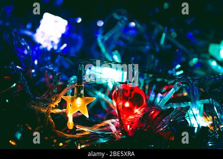 Christmas Light Decorations: Star Shaped Yellow Light and Heart Shaped Red Light with Blue and Teal Background Stock Photo