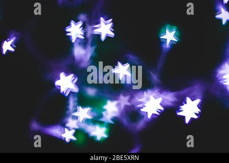 Abstract Photography with Star Shaped Lights with Purple and Green Colors on the Background Stock Photo