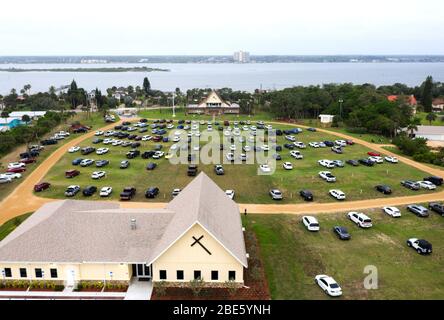 (EDITORS NOTE: Image taken with a drone) People in cars attend Easter Sunday services at the Daytona Beach Drive-in Christian Church  as a way to practice social distancing during the coronavirus pandemic. Florida's stay-at- home order exempts religious services, but Governor Ron DeSantis has advised against attending crowded religious gatherings. Stock Photo