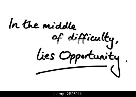 In the middle of difficulty, lies opportunity, handwritten on a white background. Stock Photo