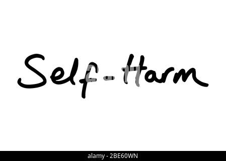 Self-Harm handwritten on a white background. Stock Photo