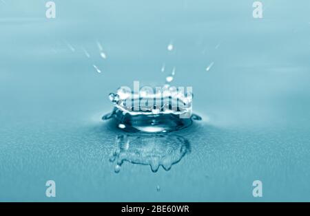 Close-up macro picture of drop on water surface, water drops splash as background Stock Photo