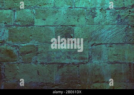 Old ancient bricks neon green and gray background,  Stock Photo