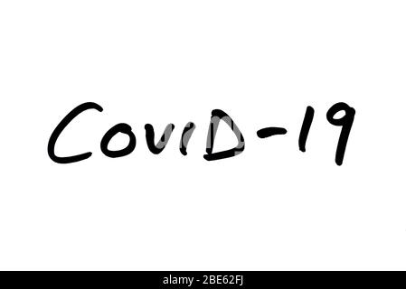 COVID-19 handwritten on a white background. Stock Photo