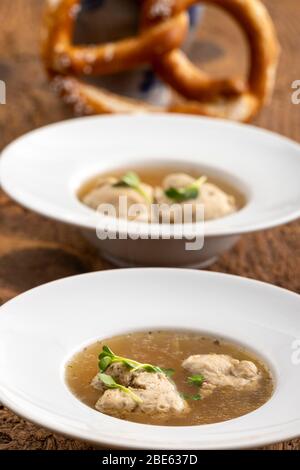bavarian meat dumpling in broth on wood Stock Photo