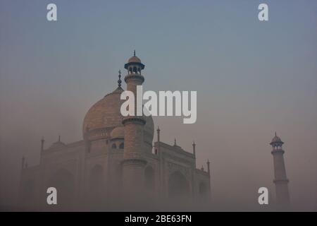 View of Taj Mahal in early morning fog, Agra, Uttar Pradesh, India. Taj Mahal was designated as a UNESCO World Heritage Site in 1983. Stock Photo
