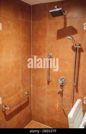 shower with seat and grab bars for disabled and elderly people in the bathroom Stock Photo