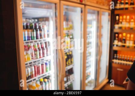 Background Blurred Defocused Beers are cooling in fridge, freezer or refrigerator shelf. Defocused Blurry Night life, Night Club, Bar, Pub, Store or G Stock Photo