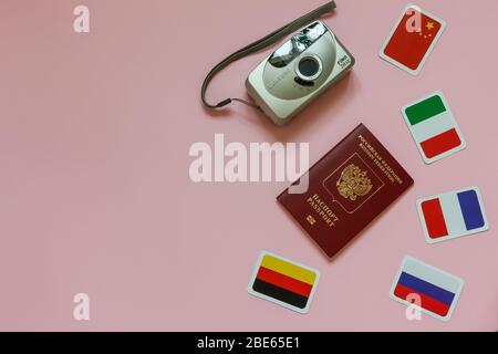 Travel concept overhead camera, passport of Russia Federation, flags of country on flatlay pink background Stock Photo