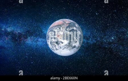 Planet Earth in deep space next to the Milky Way with blue tones in background Stock Photo