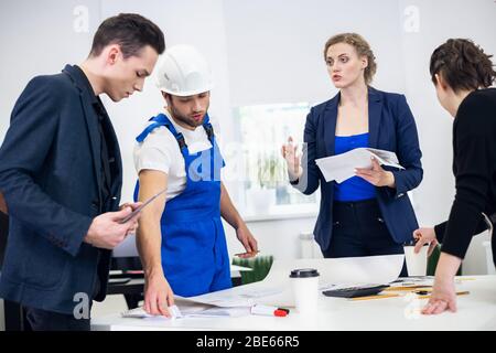 Business colleagues having a discussion on an office meeting. Creative Team Discussion. Corporate Work Concept. Modern Office. Stock Photo