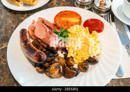 Full English Breakfast on Table with coffee Stock Photo