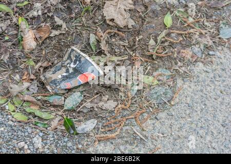 KFC takeaway drinks cup (paper?) on the side of a country road. Concept of takeaway litter, fast food rubbish. Stock Photo