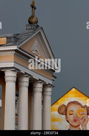 St Mary's Catholic church stands in front of a building painted with street art on Ashby Road in Loughborough, Leicestershire, UK. 12th April 2020. Stock Photo