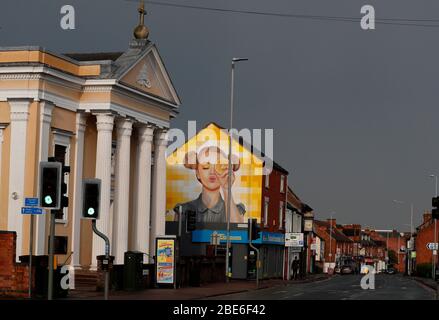 St Mary's Catholic church stands in front of a building painted with street art on Ashby Road in Loughborough, Leicestershire, UK. 12th April 2020. Stock Photo