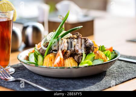 Kazan kebab on plate with a cup of tea Stock Photo