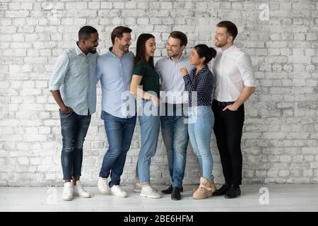 Happy multiracial businesspeople have fun talking at workplace Stock Photo