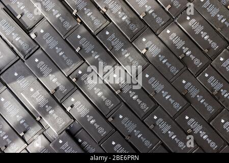 St. Petersburg, Russia - March 31, 2020: Close up of row used Li-ion Polymer batteries of Apple iPhone preparation for recycling Stock Photo
