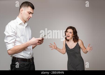 Young couple having a problem with phubbing. Stock Photo