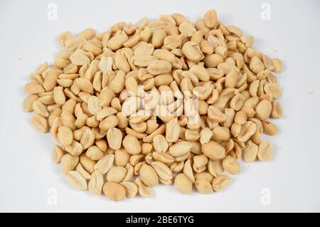 Salted and roasted peanuts on a white background Stock Photo