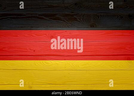 Germany flag painted on old wood plank background. Brushed natural light knotted wooden planks board texture. Wooden texture background flag of German Stock Photo