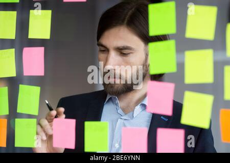 Pensive male employee do creative thinking developing startup Stock Photo