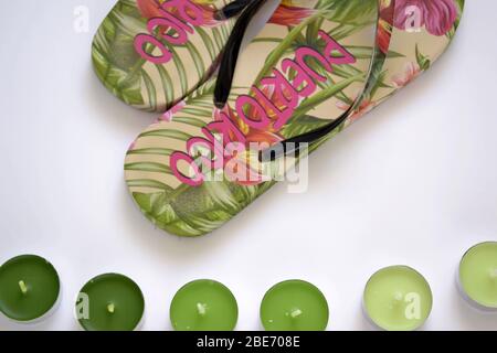 flat lay beach flip-flops from Puerto Rico with green tea light candles on the white background Stock Photo
