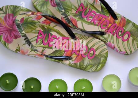flat lay beach flip-flops from Puerto Rico with green tea light candles on the white background Stock Photo