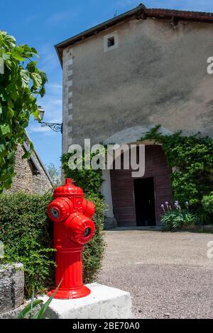 Red fire hydrant in a small French village Stock Photo