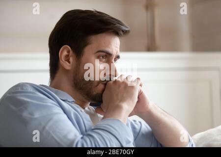 Close up head shot young thoughtful man looking away. Stock Photo
