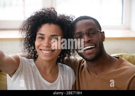 Close up headshot portrait of African American couple taking selfie. Stock Photo