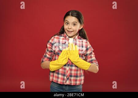 Cleaning service. Little cleaning lady red background. Small child wear rubber gloves. Domestic cleaning. Housekeeping routine. Household work. Do housework. All for cleaning. No more dust. Stock Photo