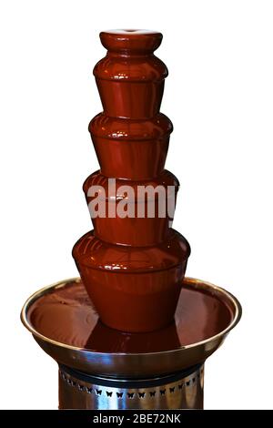 chocolate fountain machine working with dark chocolate isolated Stock Photo