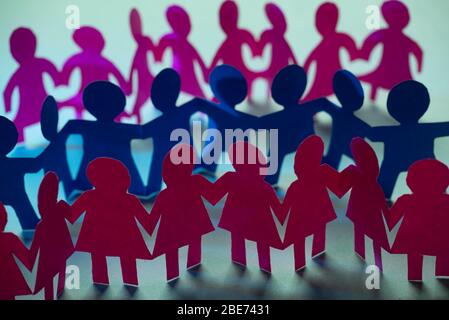 Paper dolls holding hands symbolizing union and team. Stock Photo