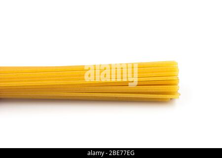Homemade spaghetti pasta heap on white isolated background in macro top view. Spaghetti is standard and popular. Pasta is delicious Italian traditiona Stock Photo