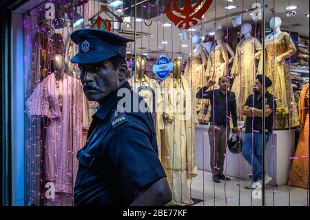 A security guard in front of a shop, Kolkata, India Stock Photo
