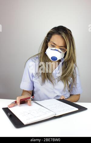 Beautiful business woman working with a surgical mask Stock Photo