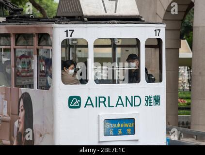 Hong Kong,China:05 Apr,2020.   Masks are warn on the tram to Shaukeiwan with the aim to stem the Covid19 spread in Central Hong Kong. Masks combined w Stock Photo