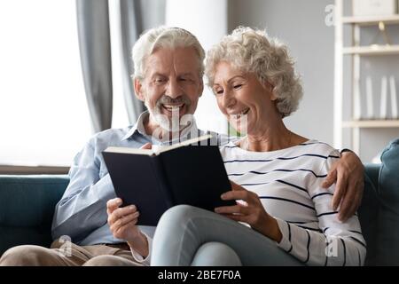 Smiling mature man and woman enjoying literature together Stock Photo