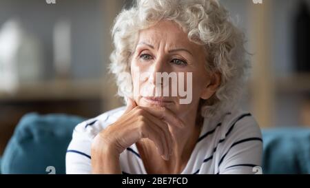 Close up thoughtful mature woman worried about problems Stock Photo