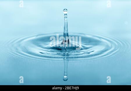 Close-up macro picture of drop on water surface, water drops splash as background Stock Photo