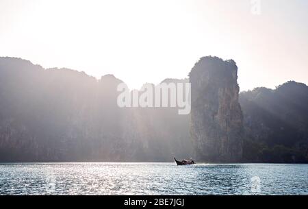 Long tail boat at tropical islands at sunrise in Andaman sea, Thailand