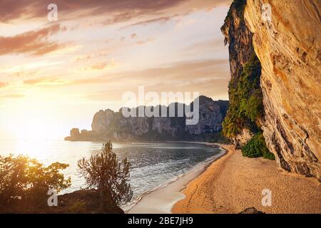 Beautiful tropical bay with sandy beach and rock at sunset in Andaman Sea, Thailand Stock Photo