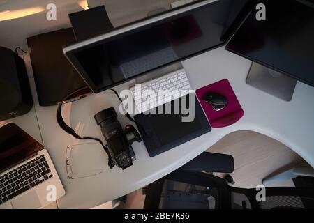 home office photographer workplace with workstation computer  and dual screen monitor modern laptop and medium format dslr camera Stock Photo