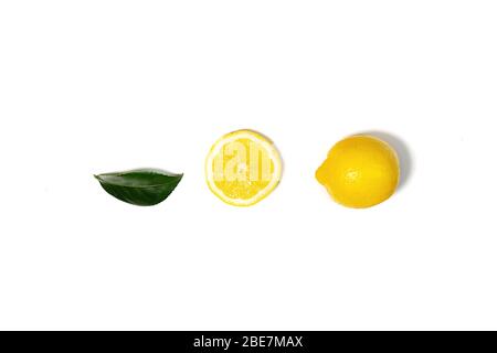 Creative layout made of lemon and green leaf. Flat lay. Food concept. Lemon on white background. Stock Photo