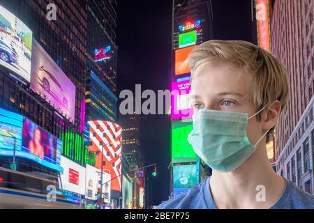 Young man in face mask on the night street. coronavirus pandemic in the night city Stock Photo